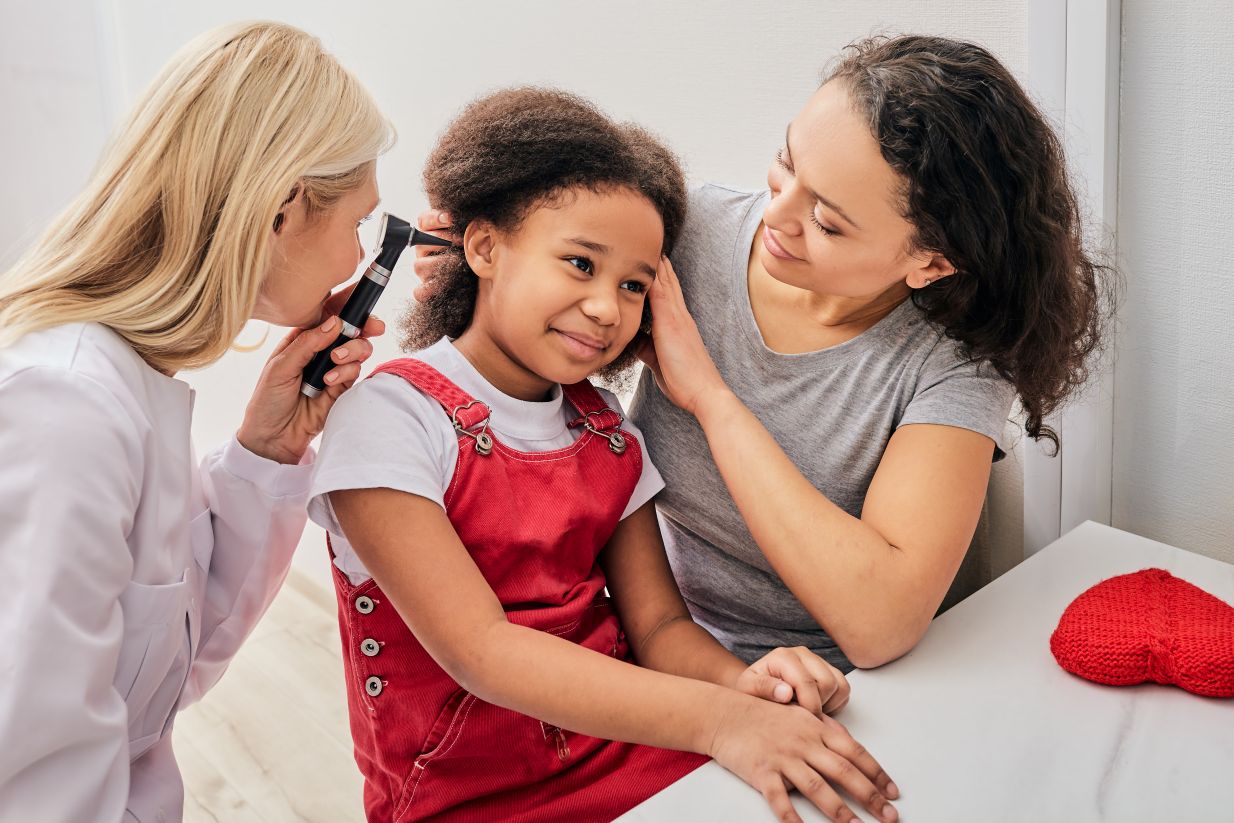 Audiologist examining a child’s ear