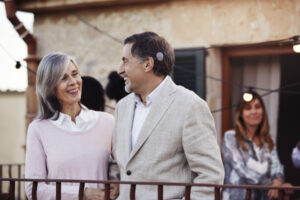 A man with his wife on a balcony while he displays his OSIA implant