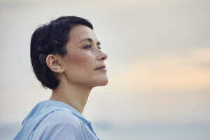A woman looking into the sunset displaying her OSIA implant